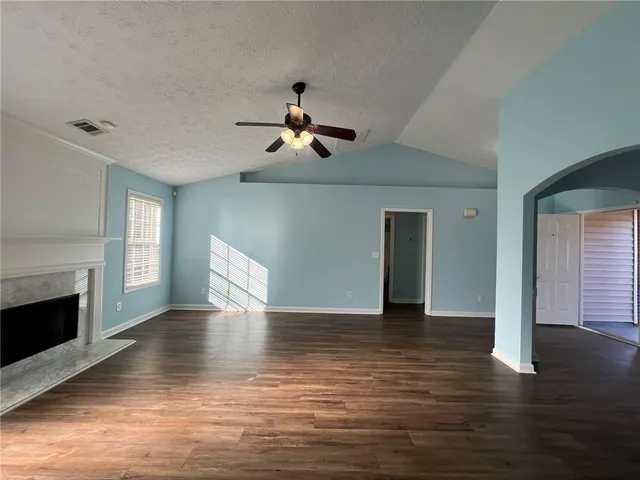 a view of a livingroom with wooden floor and a ceiling fan