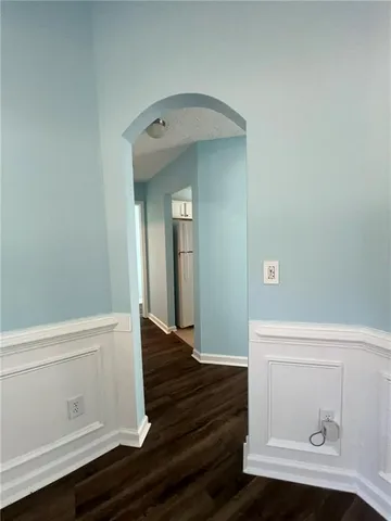 a living room with hardwood floor and a window