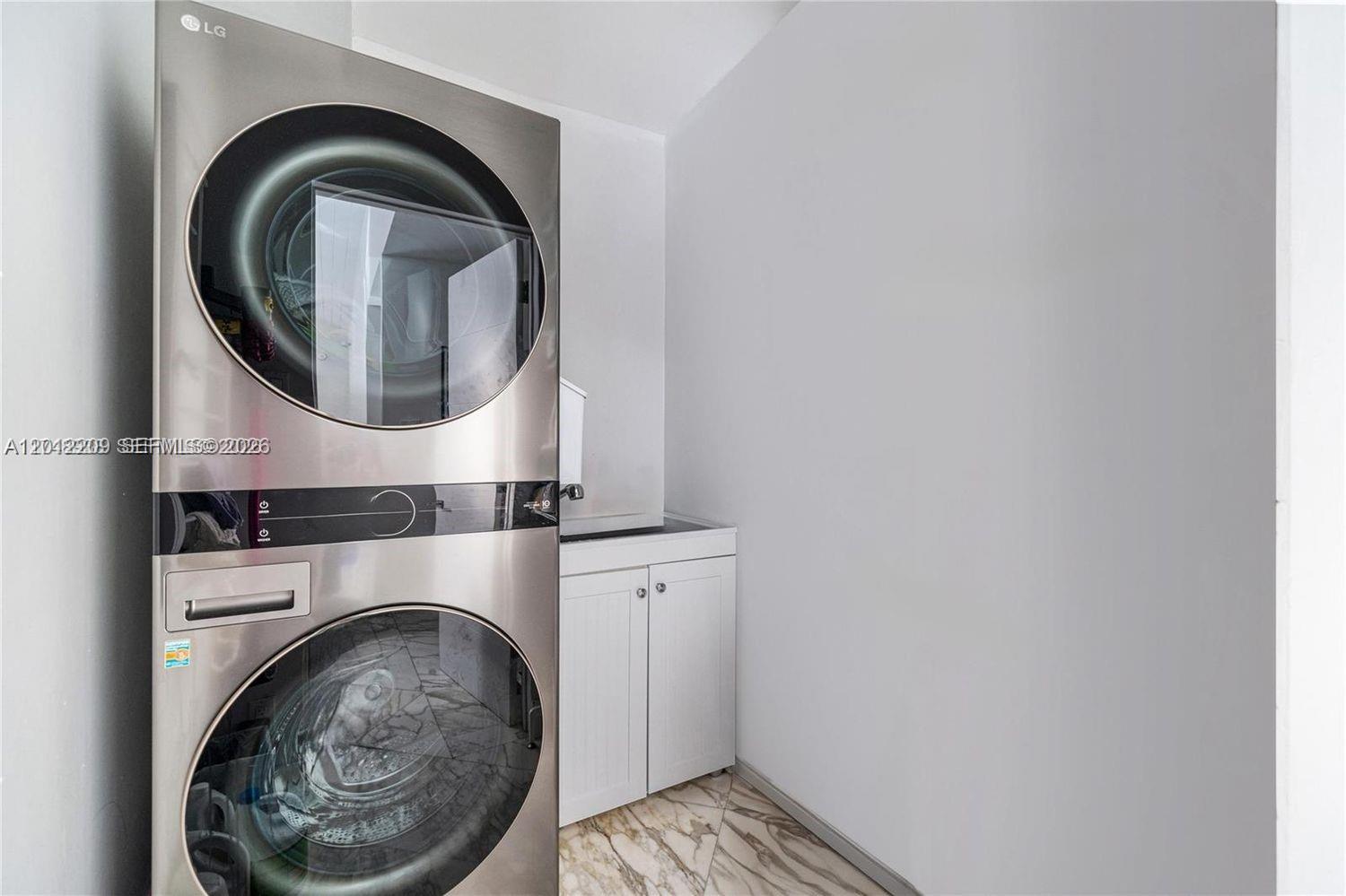 530 Sabal Palm Road Miami, FL 33137 - Photo 18 of 30 a close view of a utility room with dryer and washer