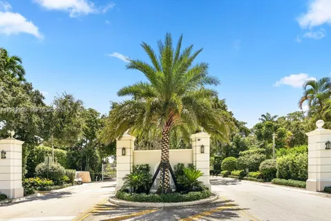 a view of a palm trees front of house