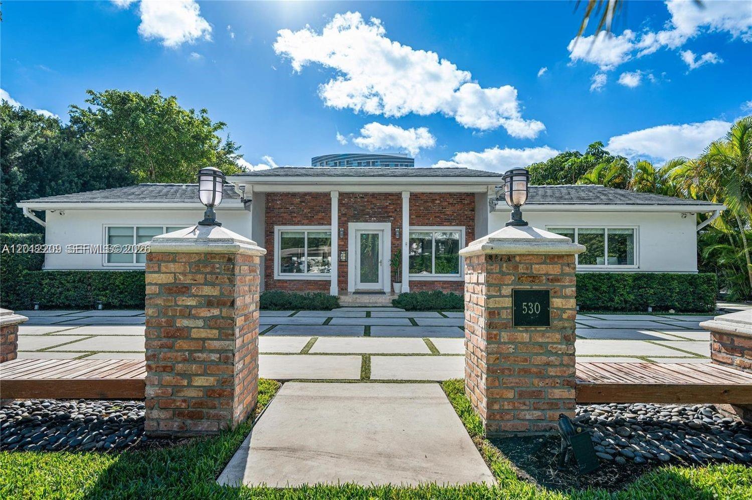 530 Sabal Palm Road Miami, FL 33137 - Photo 25 of 30 a front view of a house with a yard and outdoor seating