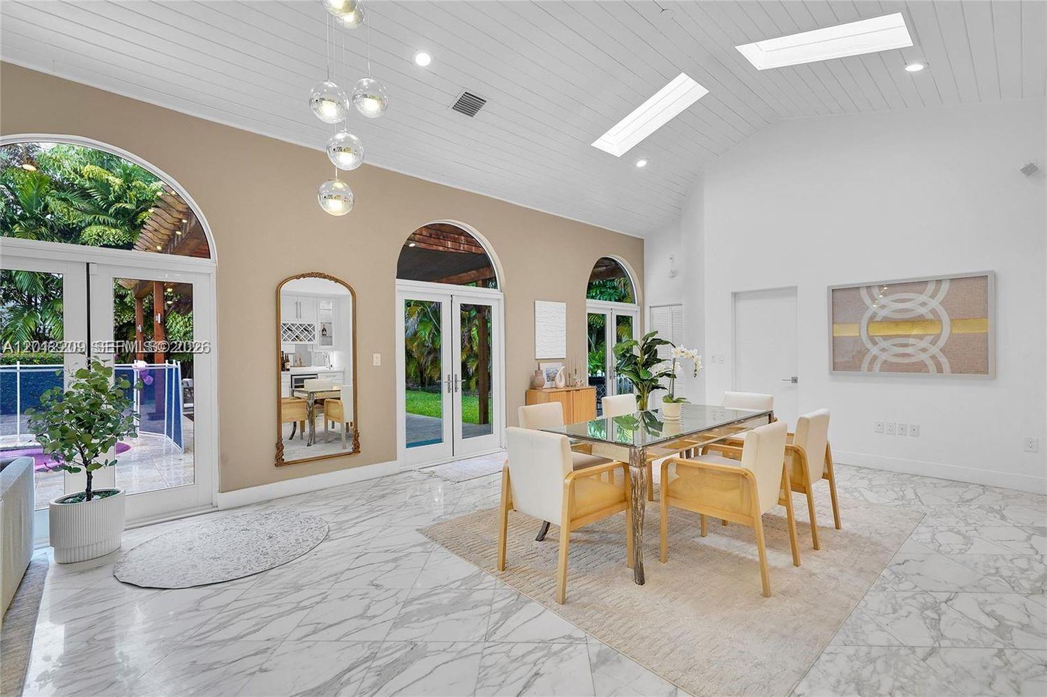 530 Sabal Palm Road Miami, FL 33137 - Photo 4 of 30 a view of a livingroom with furniture and a potted plant