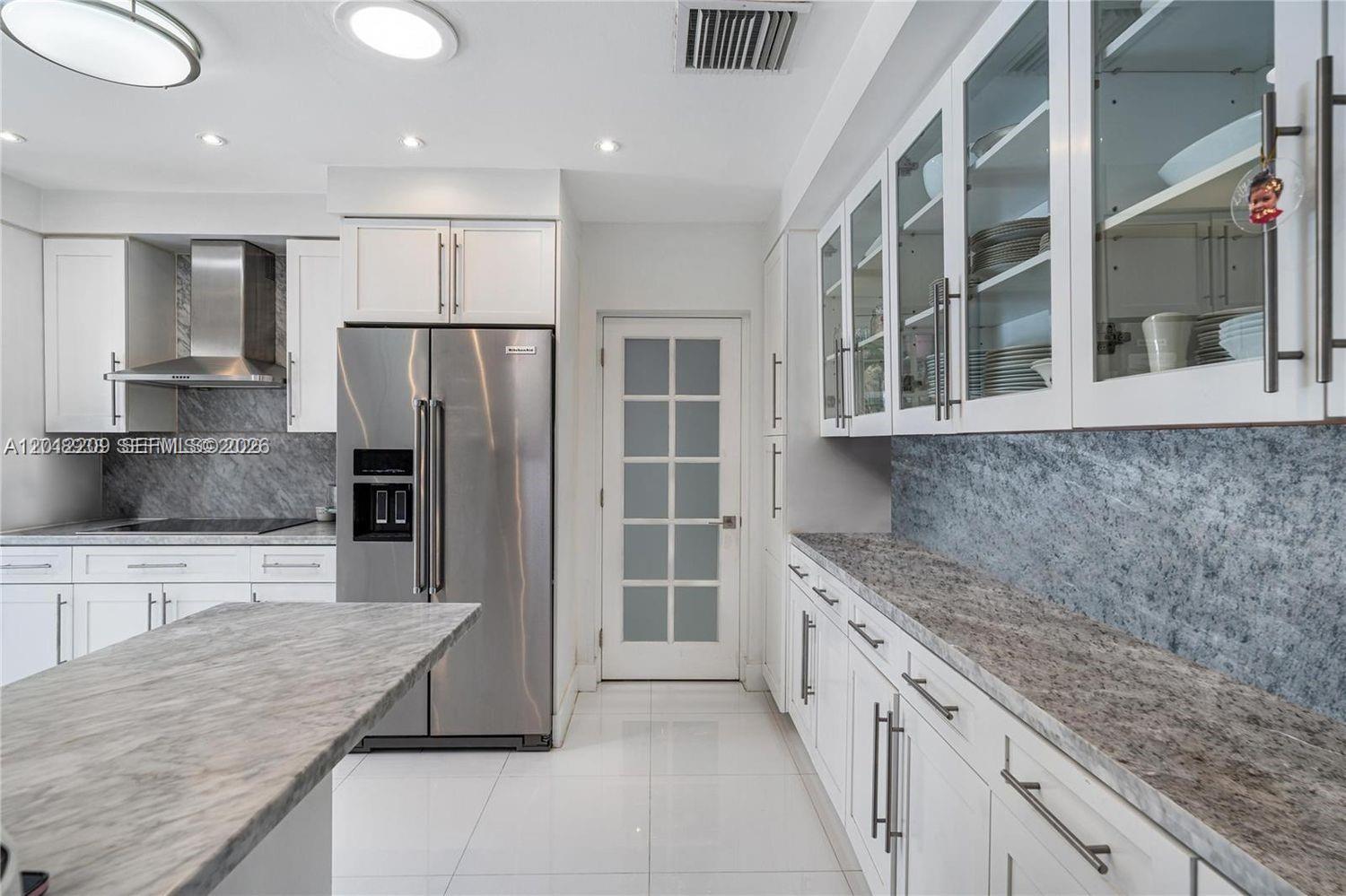 530 Sabal Palm Road Miami, FL 33137 - Photo 7 of 30 a kitchen with stainless steel appliances granite countertop a refrigerator and a sink