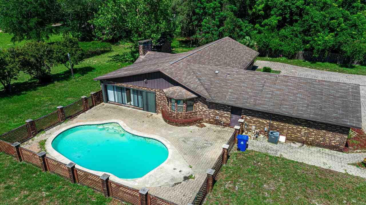 540 Ray Edwards Road St. Augustine, FL 32086 - Photo 2 of 19 Brick pool paved and fenced with bow bay seats facing pool.pool maintenance plan, pool pump system and filters