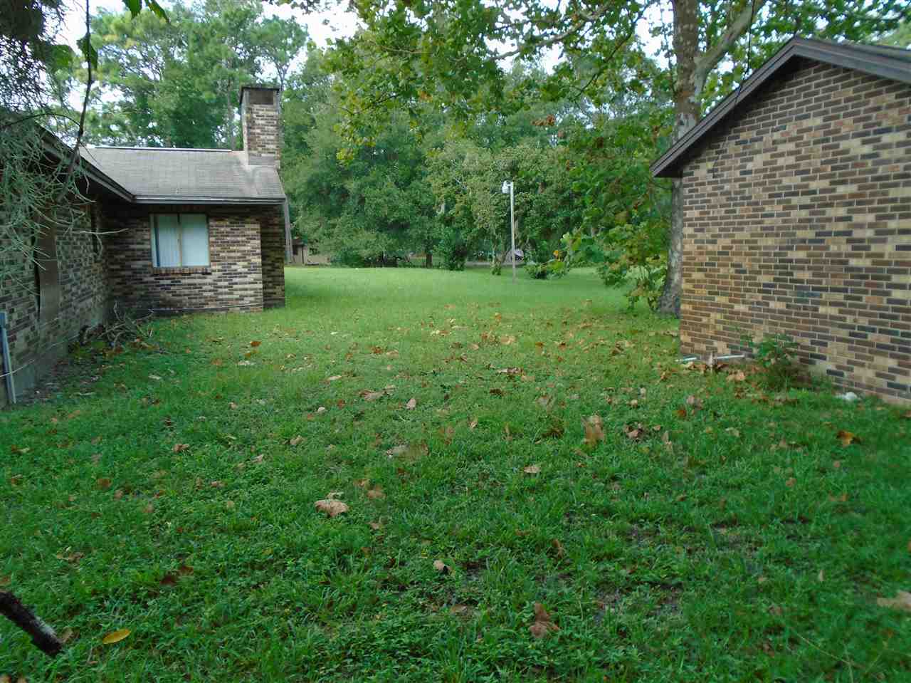 540 Ray Edwards Road St. Augustine, FL 32086 - Photo 5 of 19 Back yard with brick shed and reverse osmosis system for house and lawn watering of grape vine.Note two air conditioners