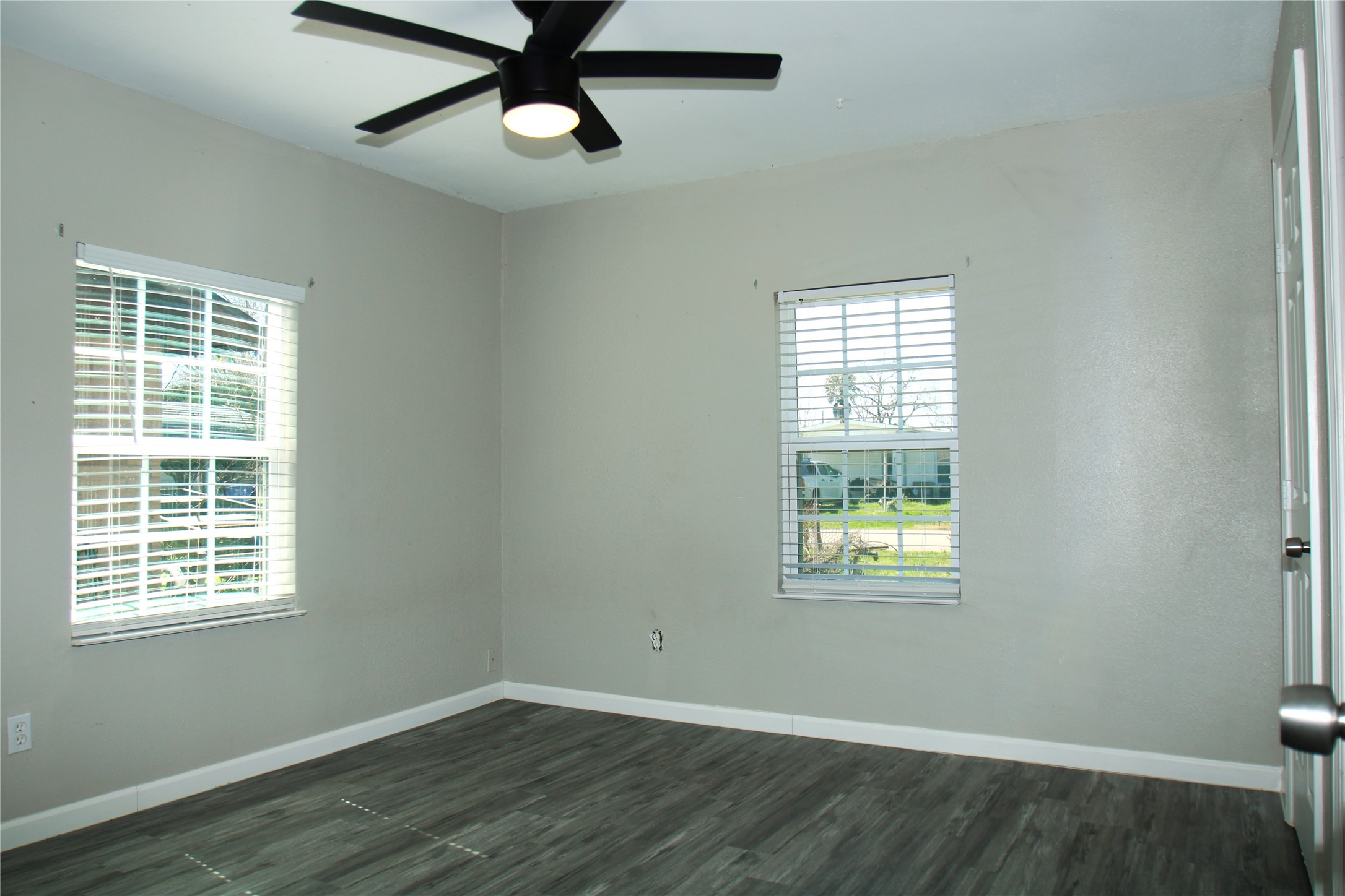 817 South Morgan Street Angleton, TX 77515 - Photo 9 of 16 a view of an empty room with wooden floor and a window