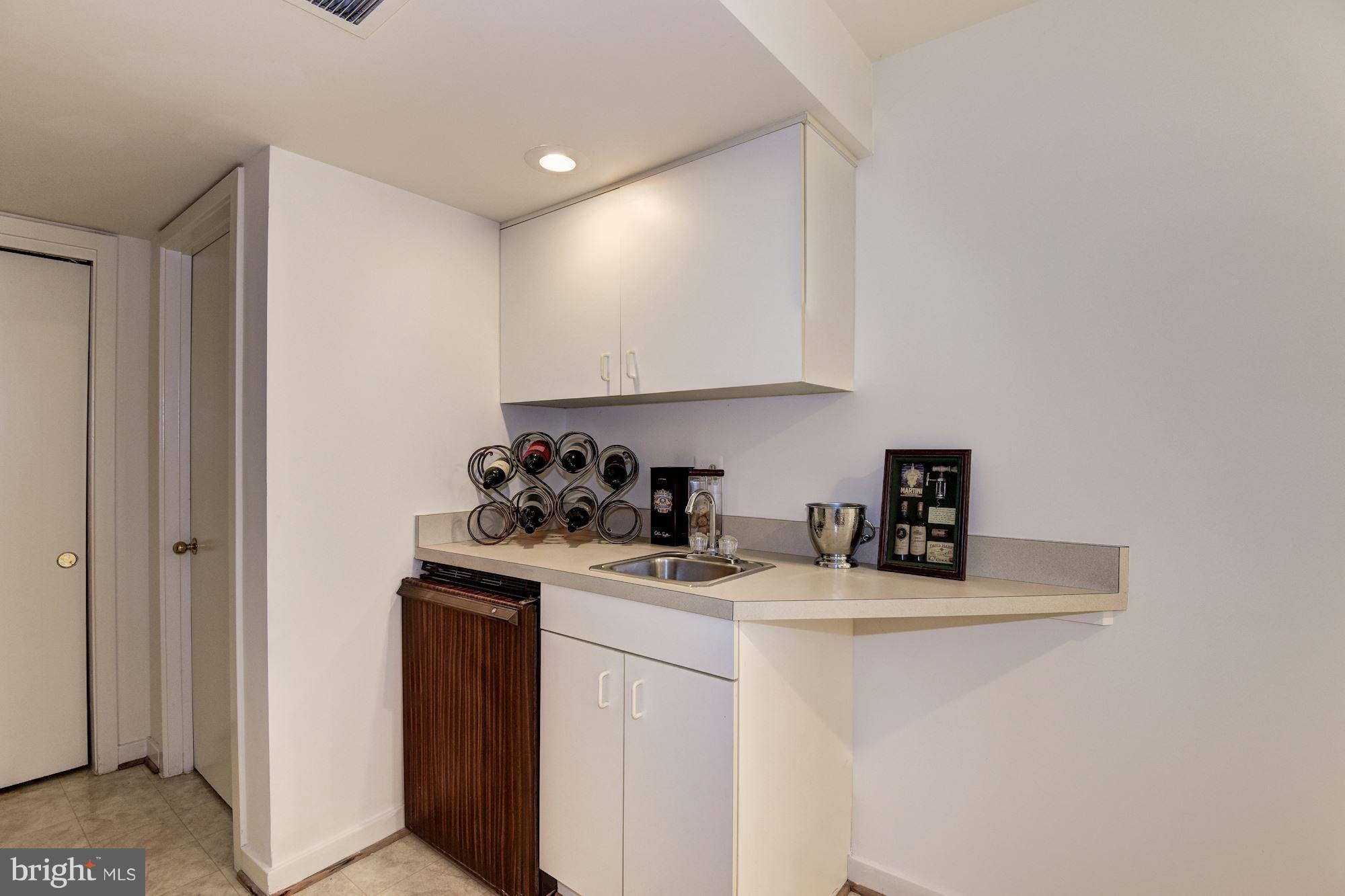 1658 Wild Pine Way Reston, VA 20194 - Photo 26 of 30 Wet Bar + Door To Unfinished Storage Room-336 SqFt