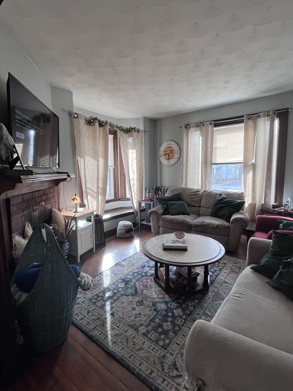 23 Sumner Terrace Springfield, MA 01108 - Photo 13 of 24 a living room with furniture a window and a flat screen tv