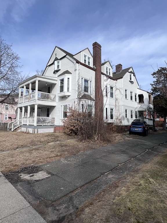 23 Sumner Terrace Springfield, MA 01108 - Photo 3 of 24 a view of a white house with large windows next to a road