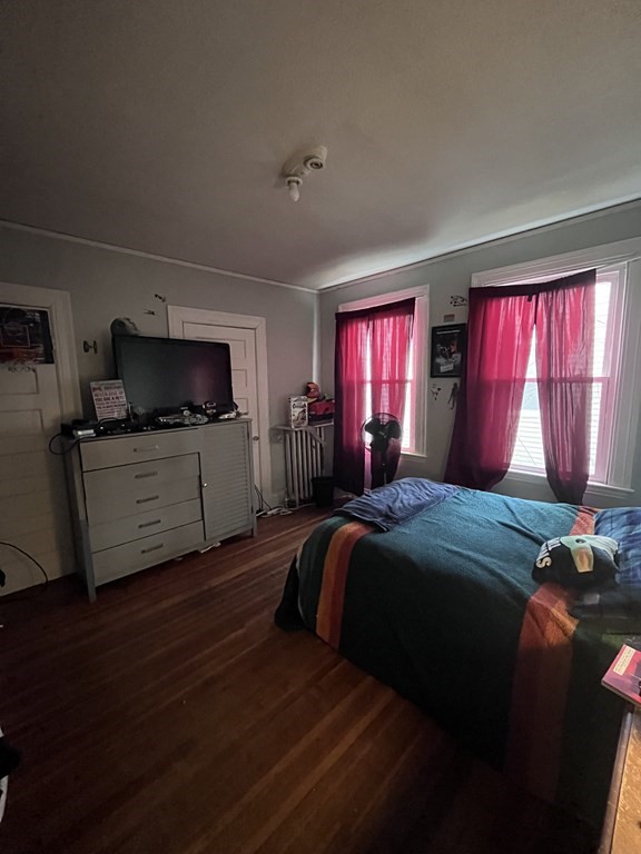23 Sumner Terrace Springfield, MA 01108 - Photo 10 of 24 a bedroom with a bed and wooden floor