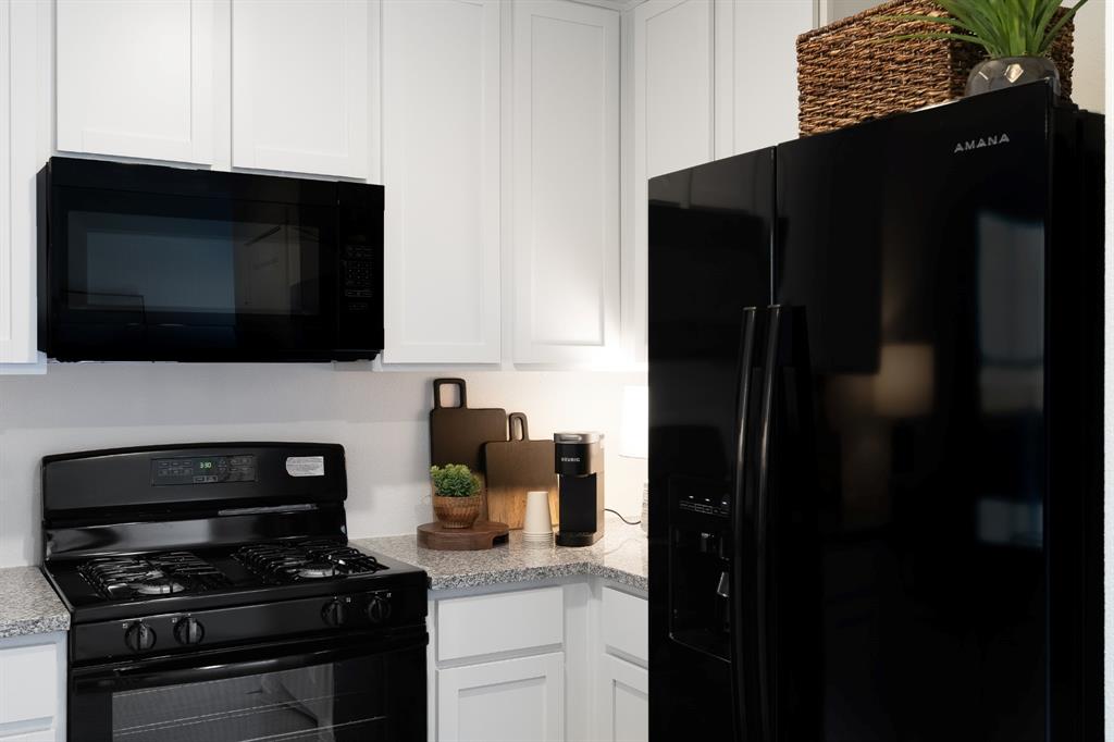 1287 Maple Street Wilmer, TX 75172 - Photo 12 of 22 a kitchen with a stove and a microwave