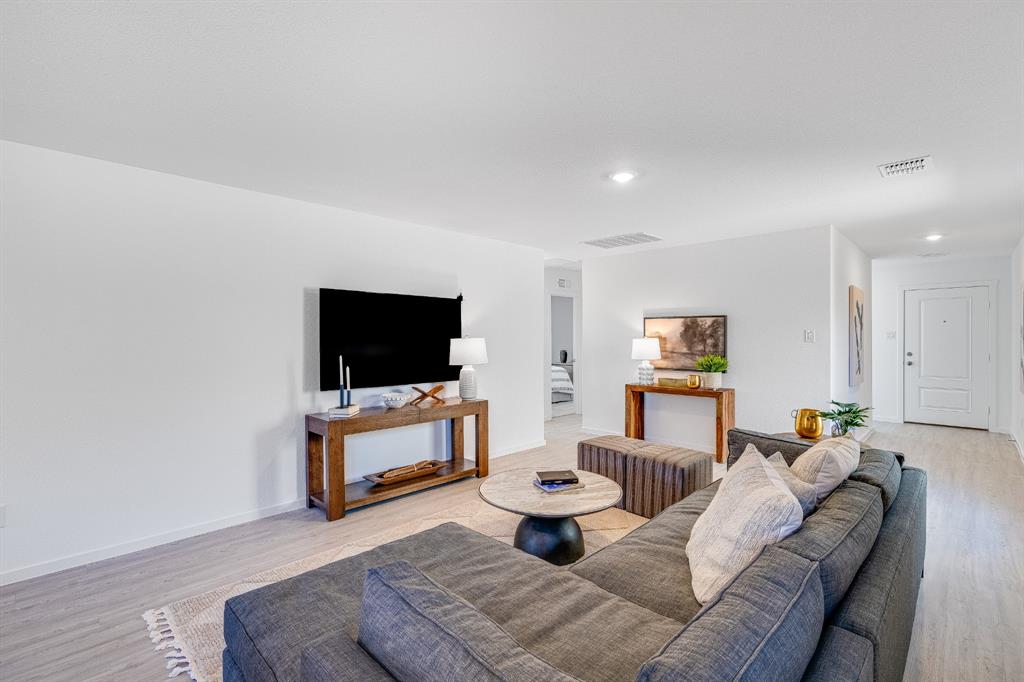 1287 Maple Street Wilmer, TX 75172 - Photo 5 of 22 a living room with furniture and a flat screen tv