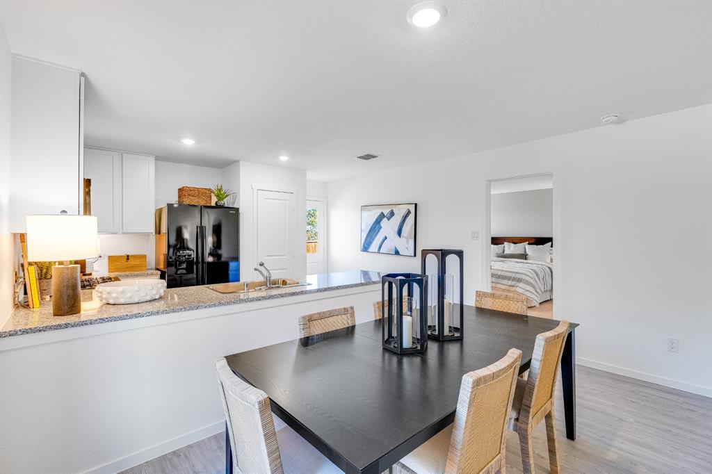 1287 Maple Street Wilmer, TX 75172 - Photo 6 of 22 a kitchen with a table and chairs