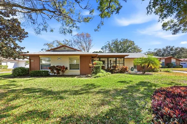 a view of a house with a backyard