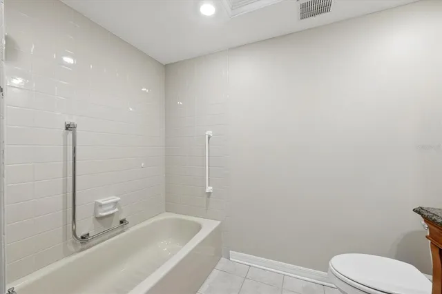 a bathroom with a toilet and a bathtub