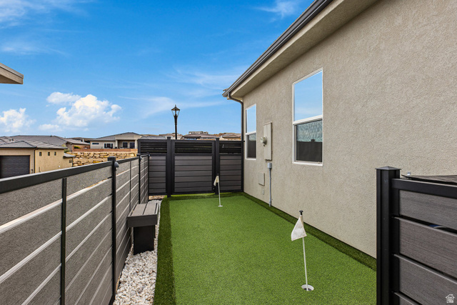 3022 West Sesia Way St. George, UT 84770 - Photo 38 of 52 View of yard featuring a balcony, a putting green, and a residential view