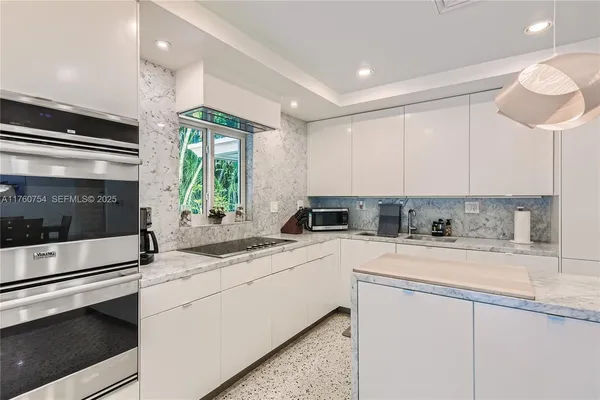 a kitchen with a sink cabinets and window