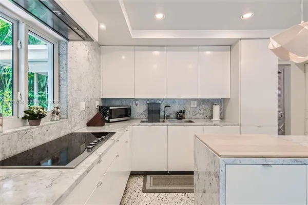 a kitchen with a stove a sink and a refrigerator