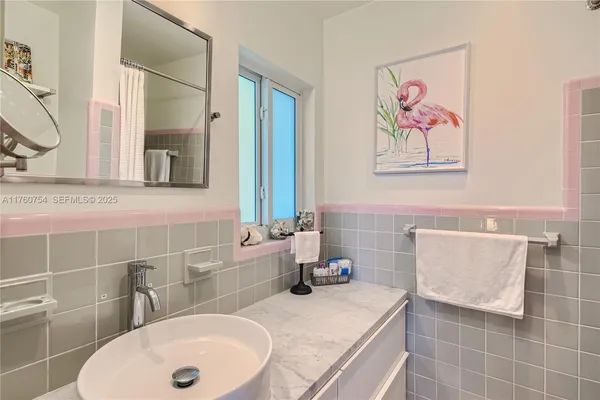 a bathroom with a tub a sink and a mirror