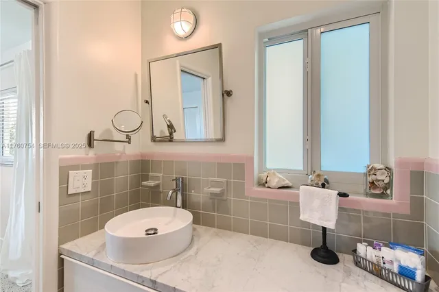 a bathroom with a sink a toilet and mirror