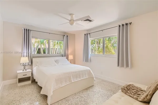 a bedroom with a large bed and a window