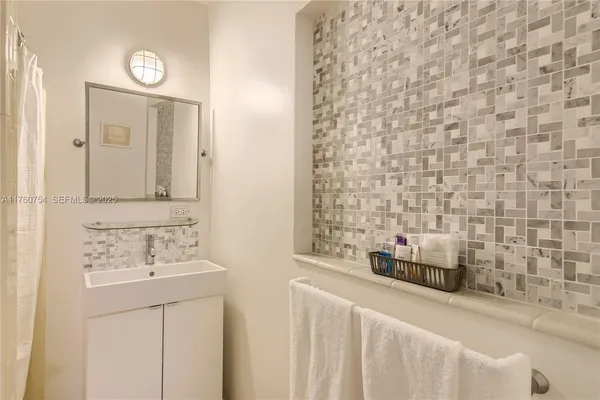a bathroom with a sink a toilet and mirror
