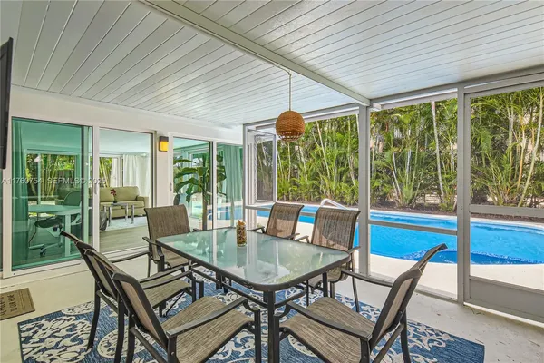 a view of a patio with a dining table and chairs
