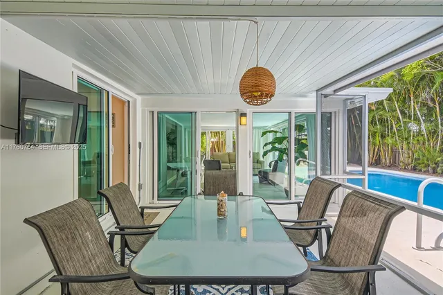 a view of a dining room with furniture wooden floor and chandelier