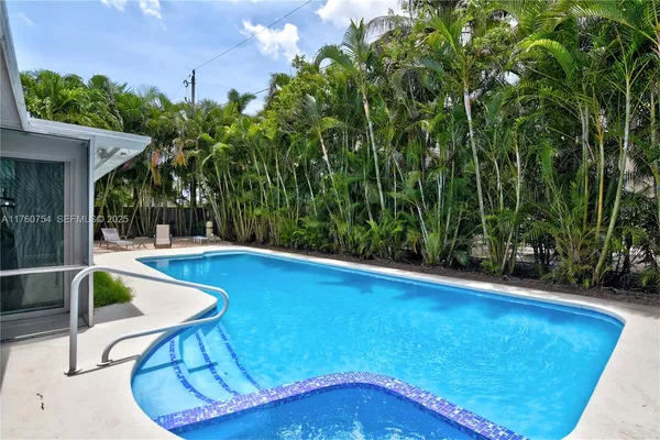a view of swimming pool with seating space