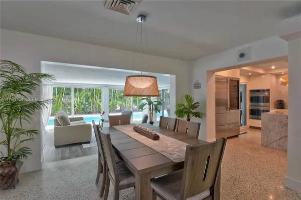 a dining room with furniture wooden floor and a potted plant