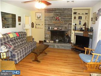 3801 Concord Road Aston, PA 19014 - Photo 8 of 12 a living room with furniture a flat screen tv and a fireplace
