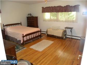 3801 Concord Road Aston, PA 19014 - Photo 9 of 12 a bedroom with a bed a dresser and a window