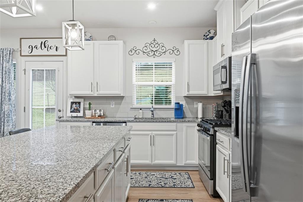 102 Rivulet Place Zelienople, PA 16063 - Photo 11 of 35 a kitchen with stainless steel appliances granite countertop a sink stove and refrigerator