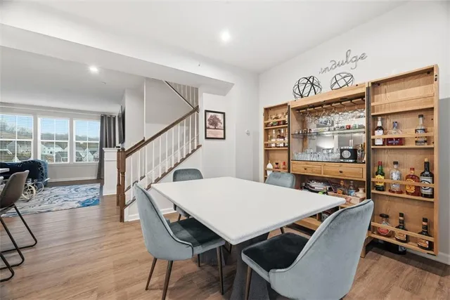 a dining room with furniture and wooden floor