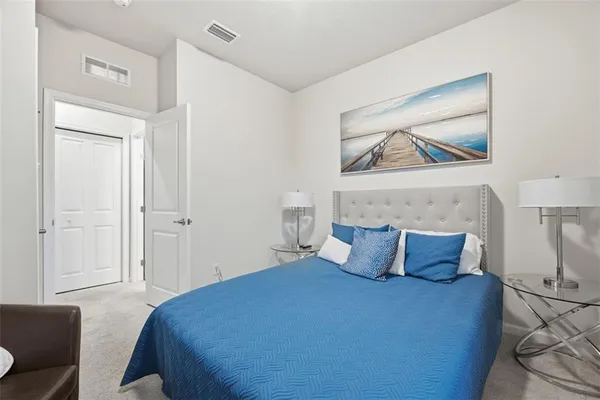 a bedroom with a bed and wall painting
