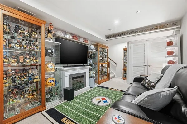 a living room with furniture a flat screen tv and a fireplace