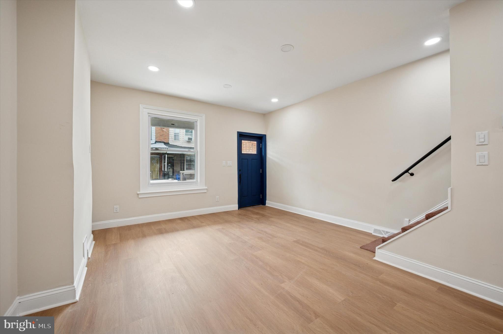 5617 Walton Avenue Philadelphia, PA 19143 - Photo 11 of 28 a view of an empty room with a window and wooden floor
