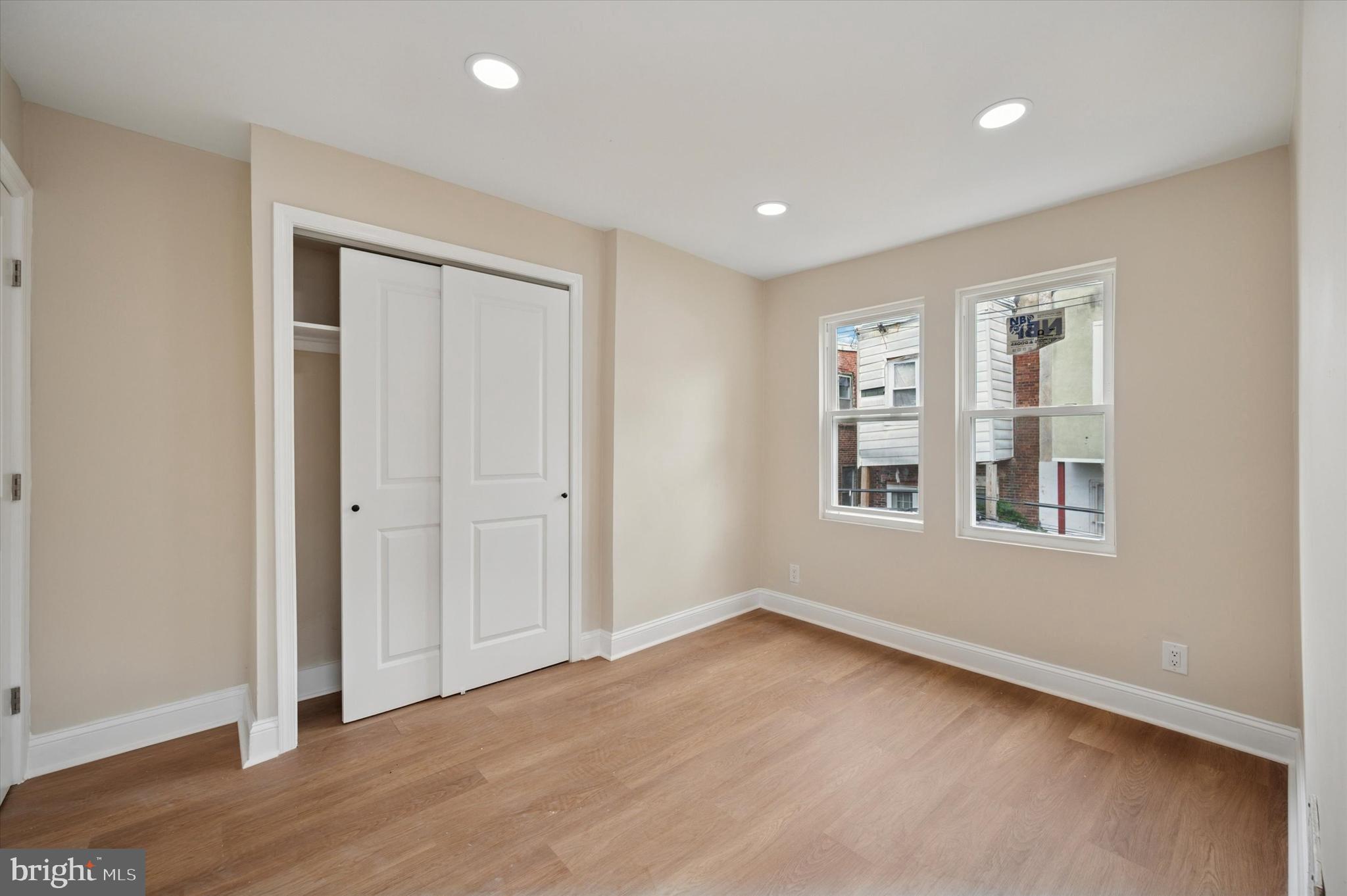 5617 Walton Avenue Philadelphia, PA 19143 - Photo 13 of 28 an empty room with wooden floor and windows