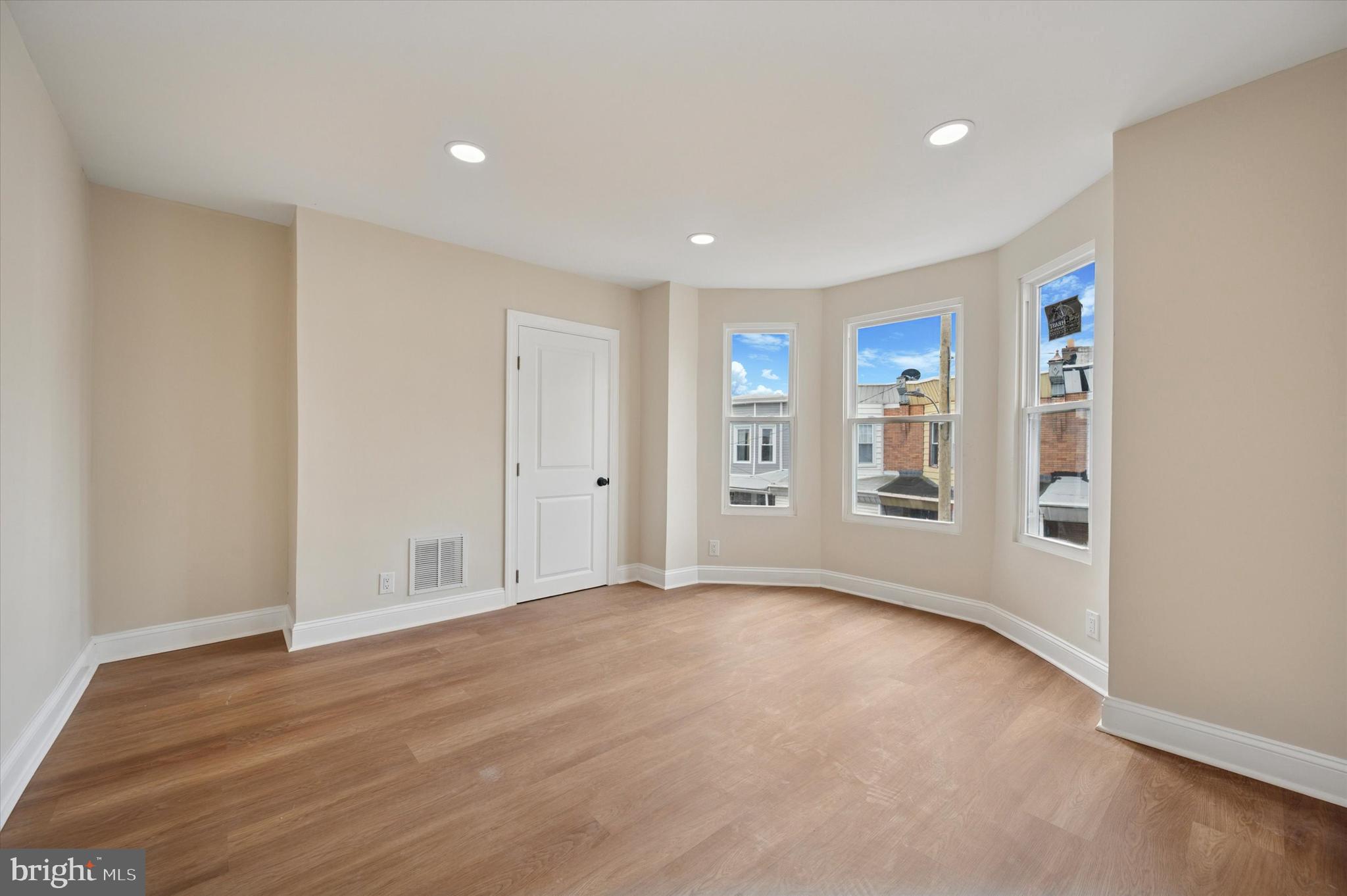 5617 Walton Avenue Philadelphia, PA 19143 - Photo 16 of 28 a view of an empty room with wooden floor and closet