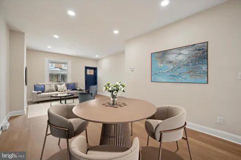 a dining room with furniture and wooden floor