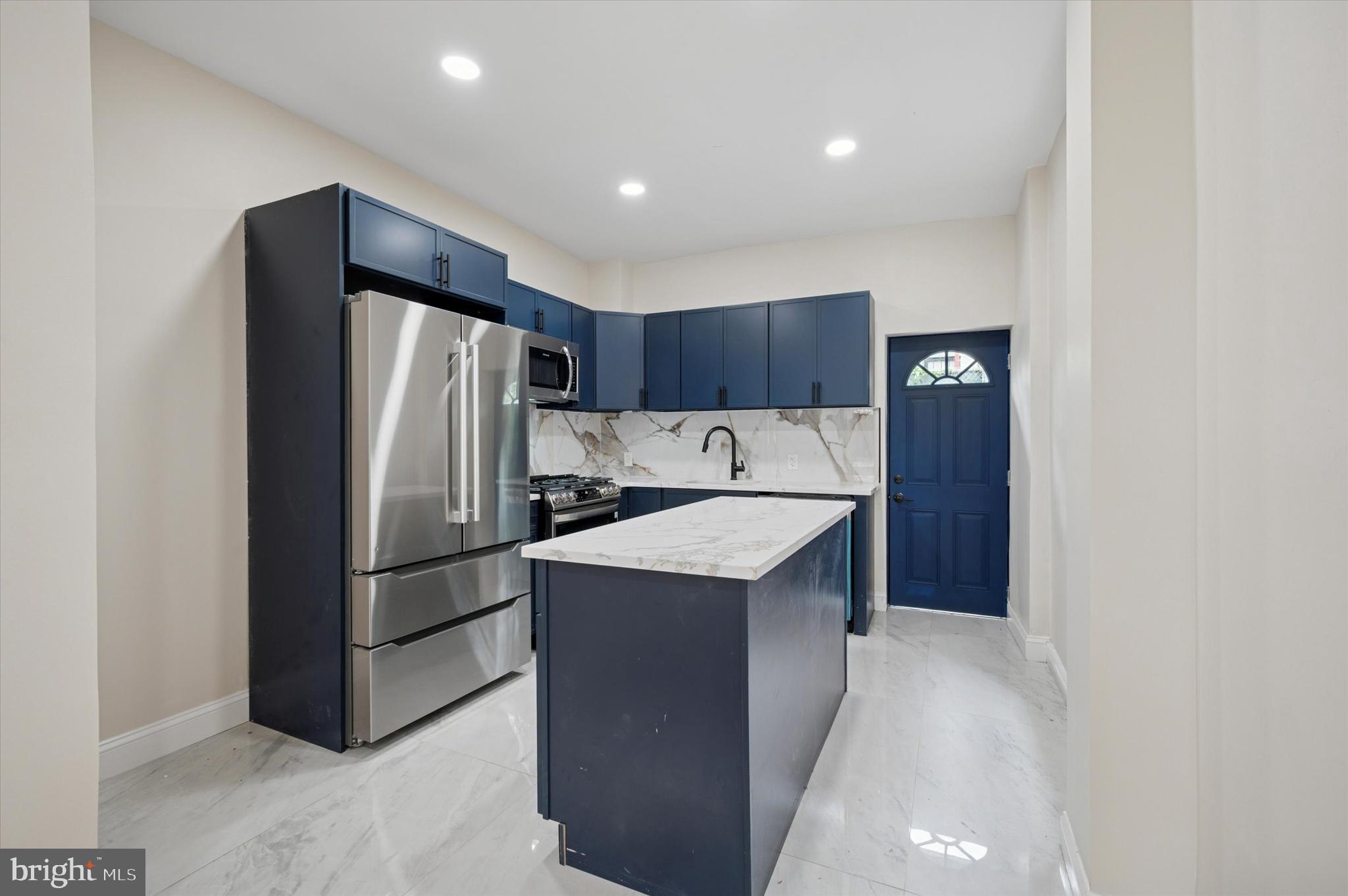 5617 Walton Avenue Philadelphia, PA 19143 - Photo 5 of 28 a kitchen with refrigerator and cabinets