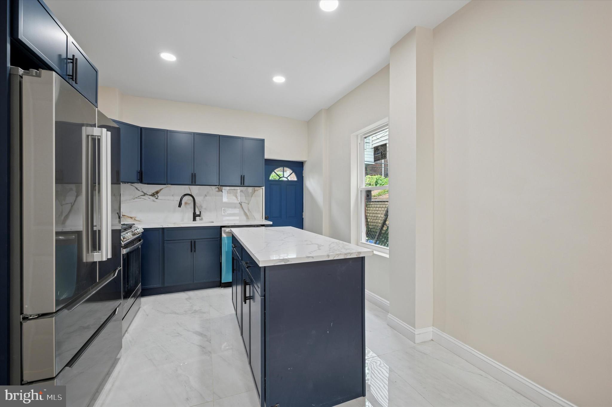 5617 Walton Avenue Philadelphia, PA 19143 - Photo 6 of 28 a kitchen with stainless steel appliances a refrigerator sink and wooden cabinets