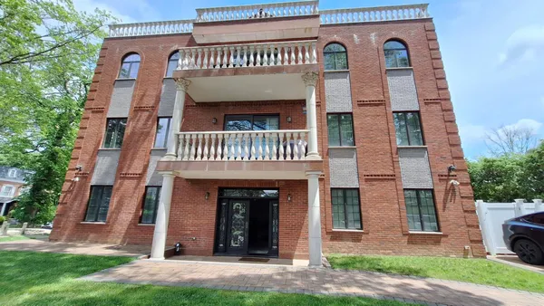 a view of a brick building with many windows