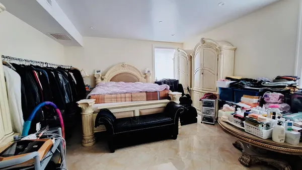 a utility room with dryer washer and a view of living room