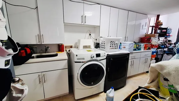 a kitchen with a table chairs and a refrigerator