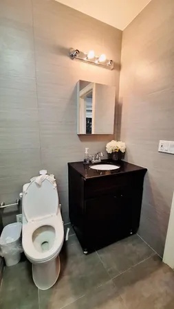 a bathroom with a sink a toilet and mirror