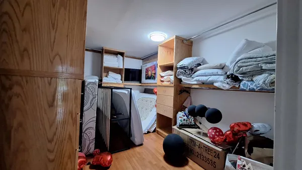 a view of a livingroom with furniture and a window