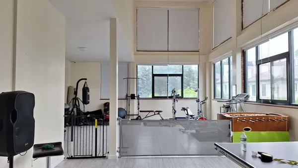 a view of a livingroom with workspace and a window