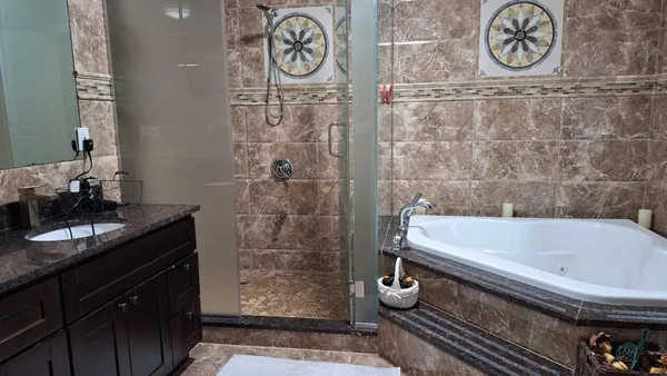 a view of a hallway with wooden floor and stairs