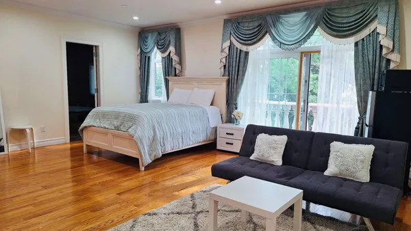 a bedroom with a bed and a desk